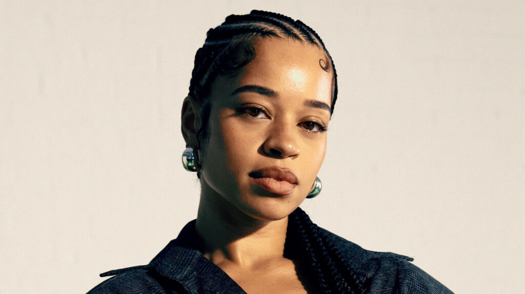 Ella Mai poses with her hair styled in braids.